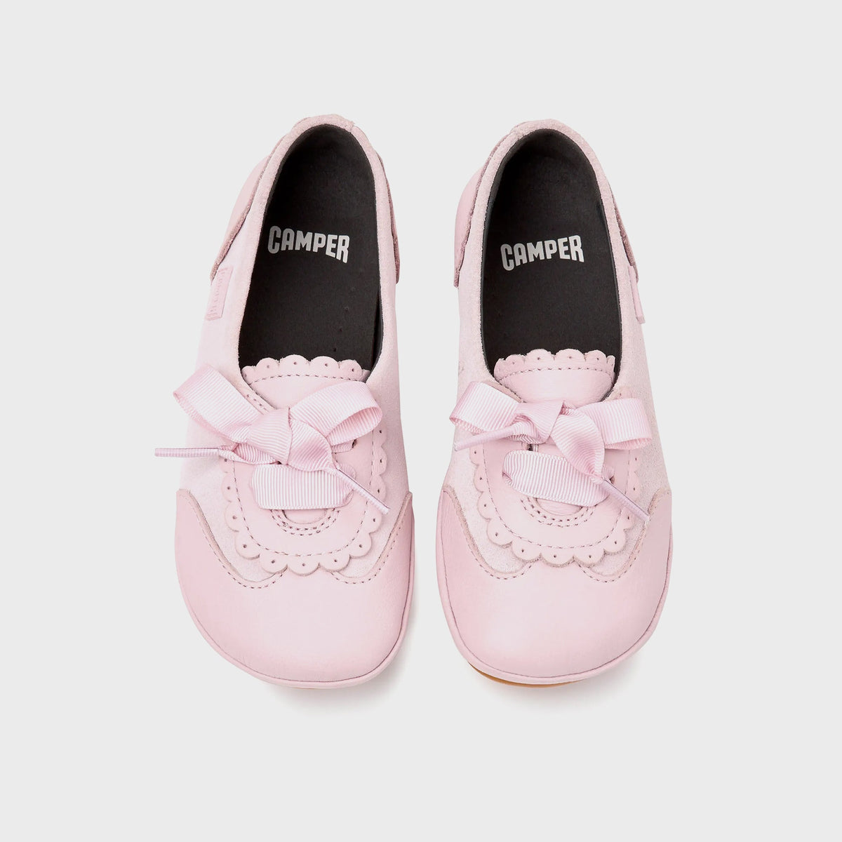 Camper Kids pink Mary Jane flats, top-down pair view with CAMPER branded insoles and bow lacing