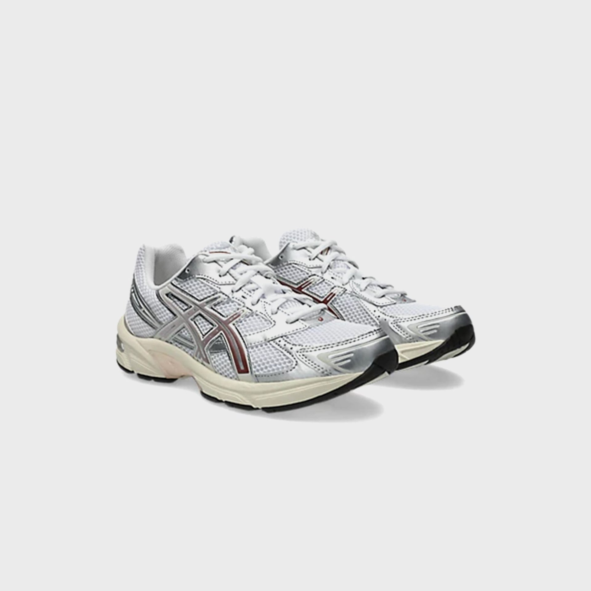 ASICS GEL-1130 in White and Rusted Rock, front three-quarter view of the pair with cream midsoles
