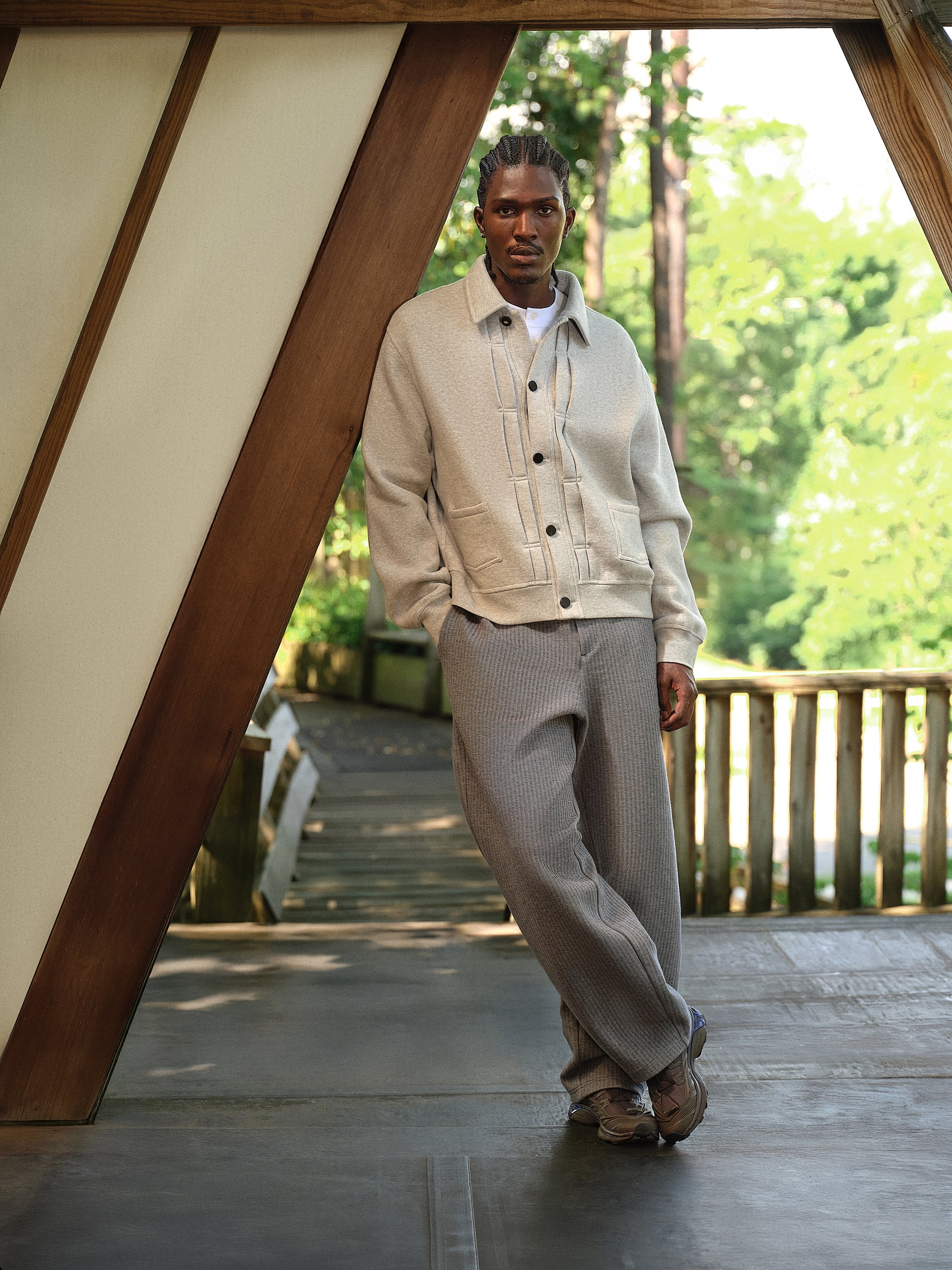 Top-down view of a blue and grey Salomon XT sneaker with Kith insole on wood planks