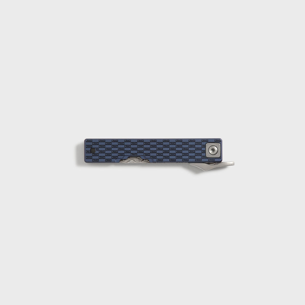 Kith x Benchmade Yamori folding knife closed, reverse side showing the pivot screw and navy checkerboard handle, Nocturnal colorway