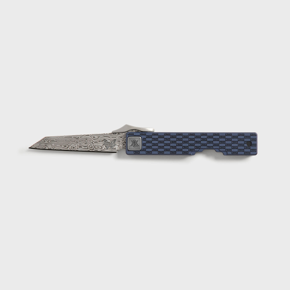 Kith x Benchmade Yamori folding knife open, showing damascus steel blade and navy handle engraved with KITH checkerboard pattern, Nocturnal colorway