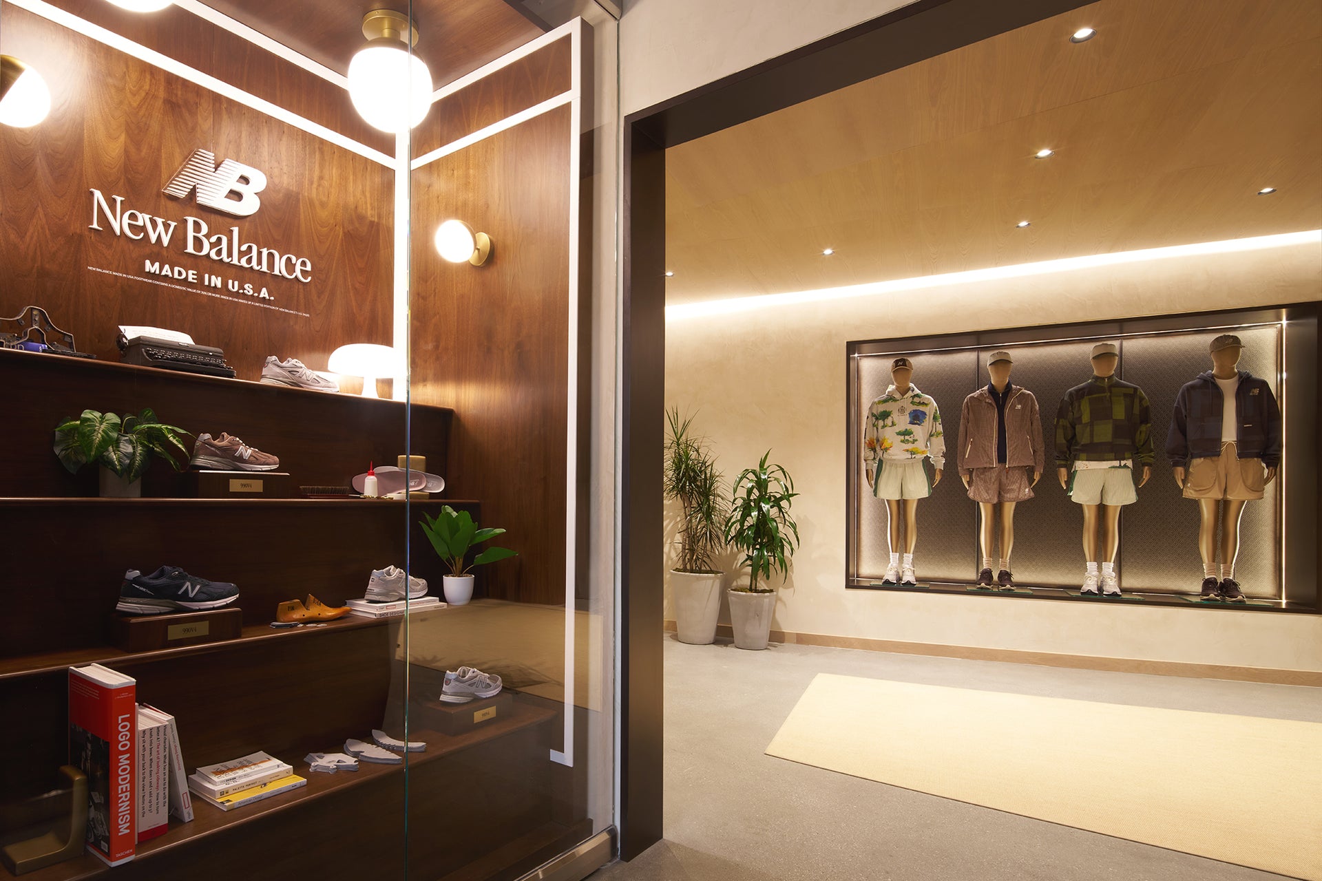 New Balance Made in USA shop-in-shop display with wood shelving of sneakers and mannequins in coordinated outfits