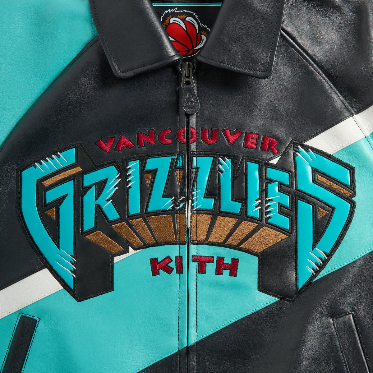 Kith & AVIREX for the Vancouver Grizzlies Jacket close-up of front zip collar with Vancouver Grizzlies chest logo and Kith wordmark