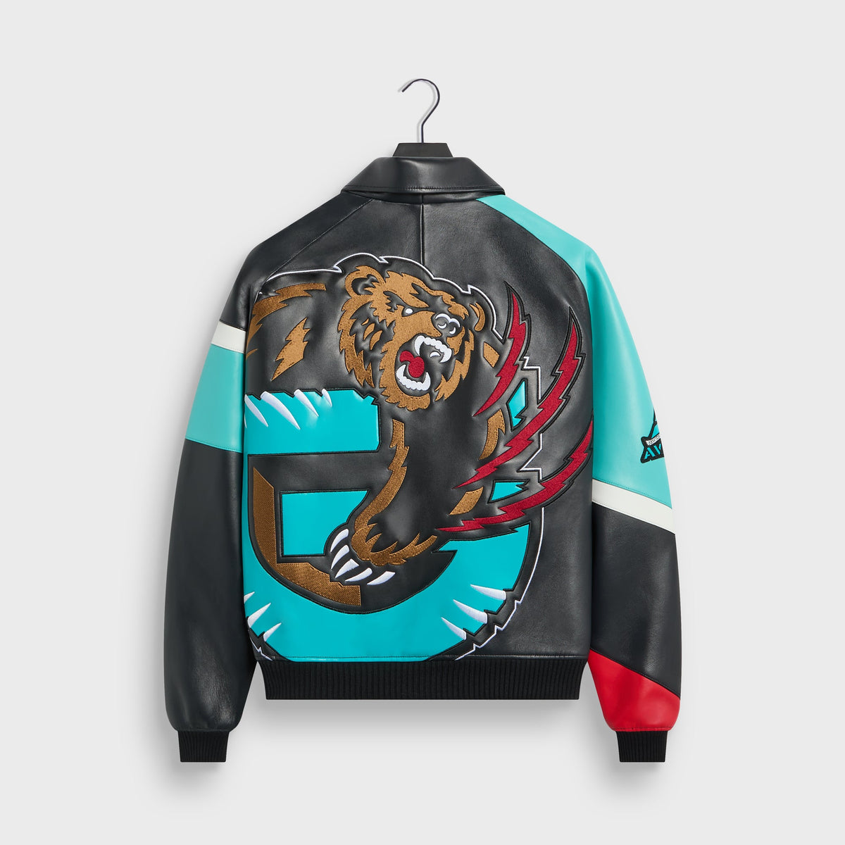 Kith & AVIREX for the Vancouver Grizzlies Jacket in multi, back view with large embroidered Grizzlies bear and teal G logo on black leather