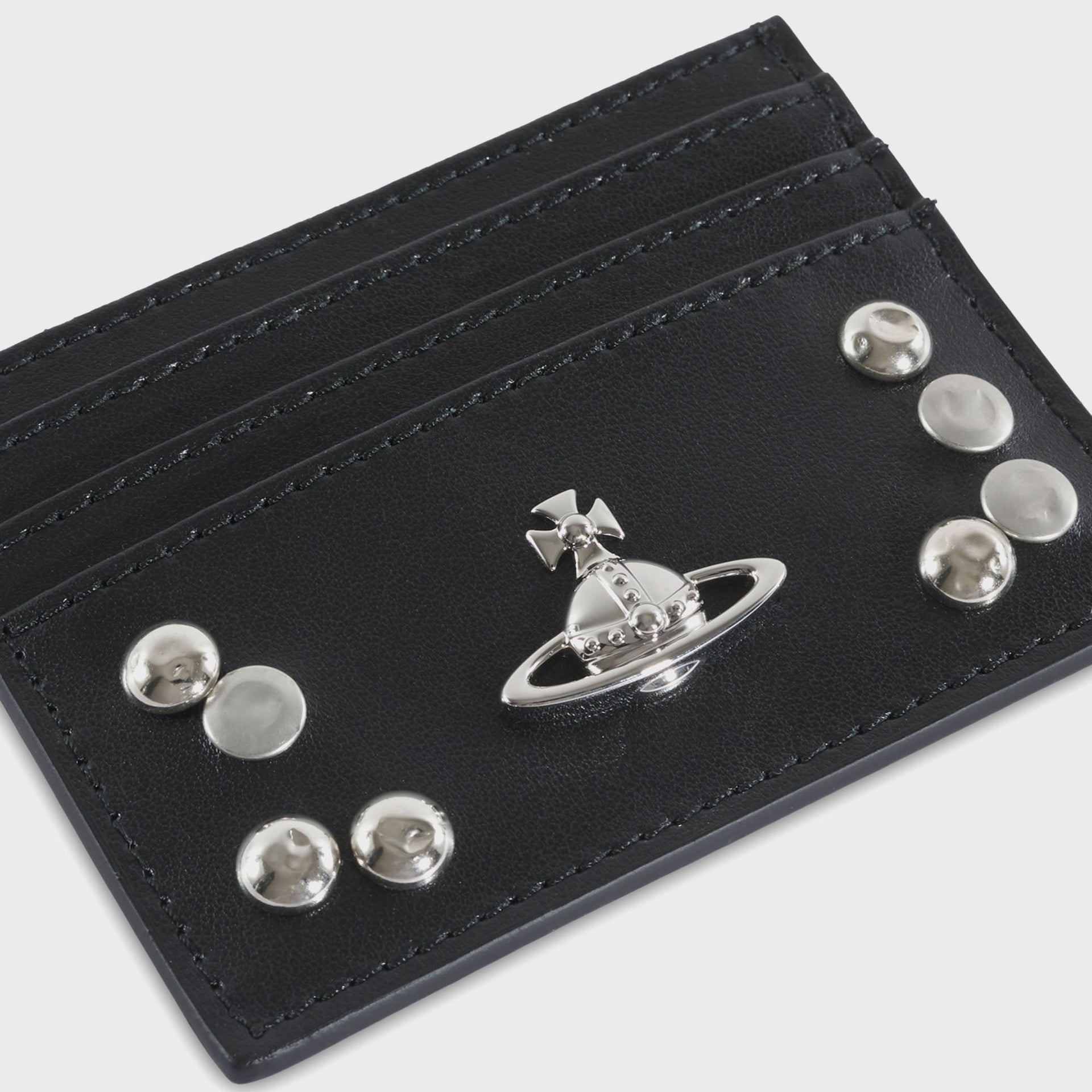 Vivienne Westwood black card holder, close-up detail of silver Orb emblem and clustered dome studs