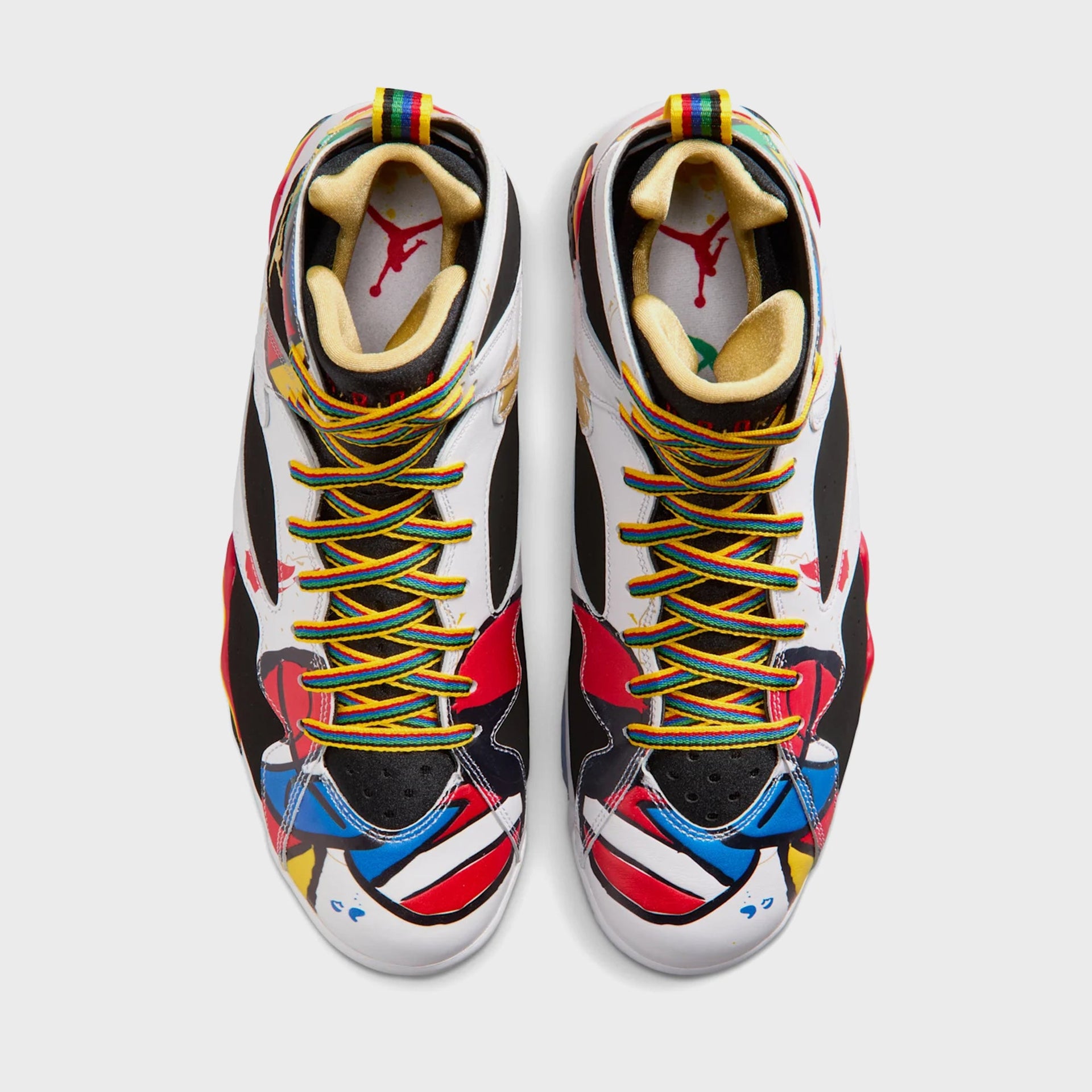 Overhead view of a pair of Air Jordan 7 Retro sneakers showing multicolor laces, gold lining and red Jumpman insoles