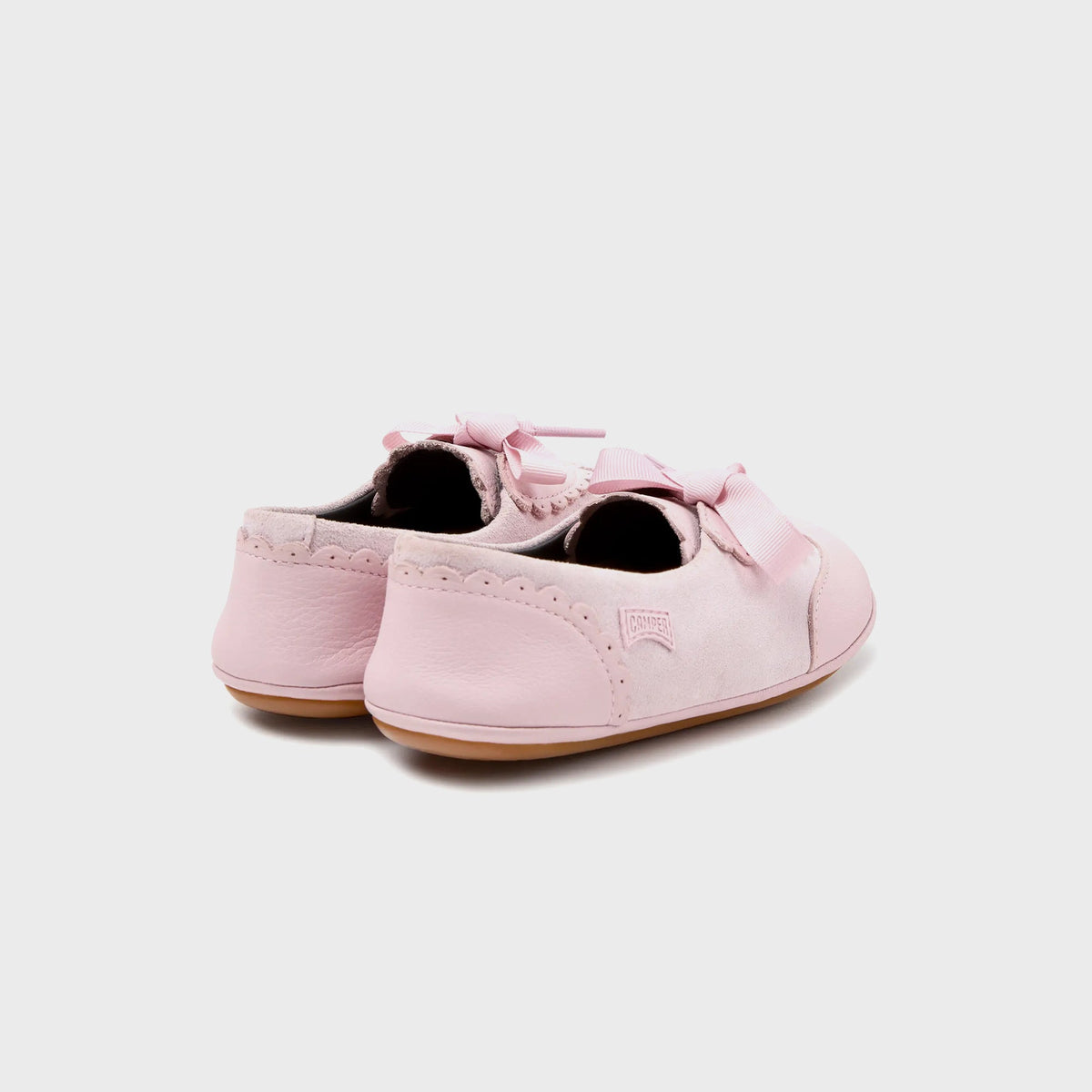 Camper Kids pink suede Mary Jane flats, rear three-quarter view showing scalloped heel trim on both shoes