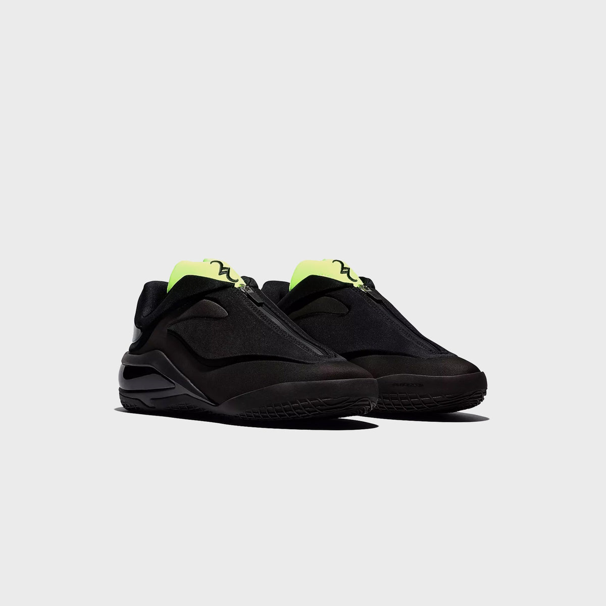 Converse SHAI 001 Ox pair in black with green branded pull tabs, front angled view
