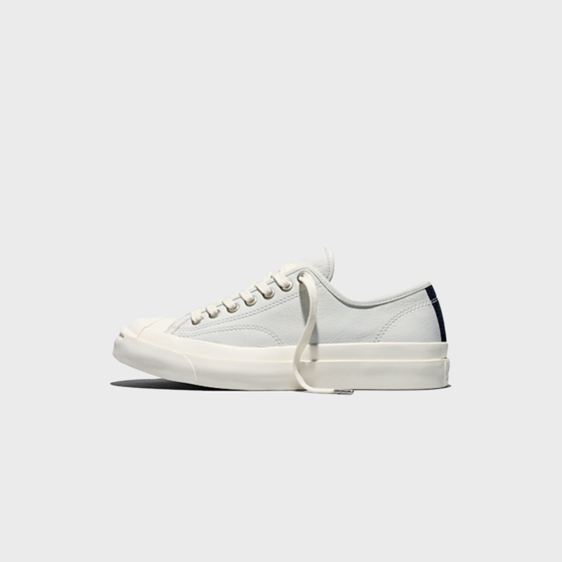 Converse Jack Purcell Premium white leather sneaker, left side profile view showing toe cap