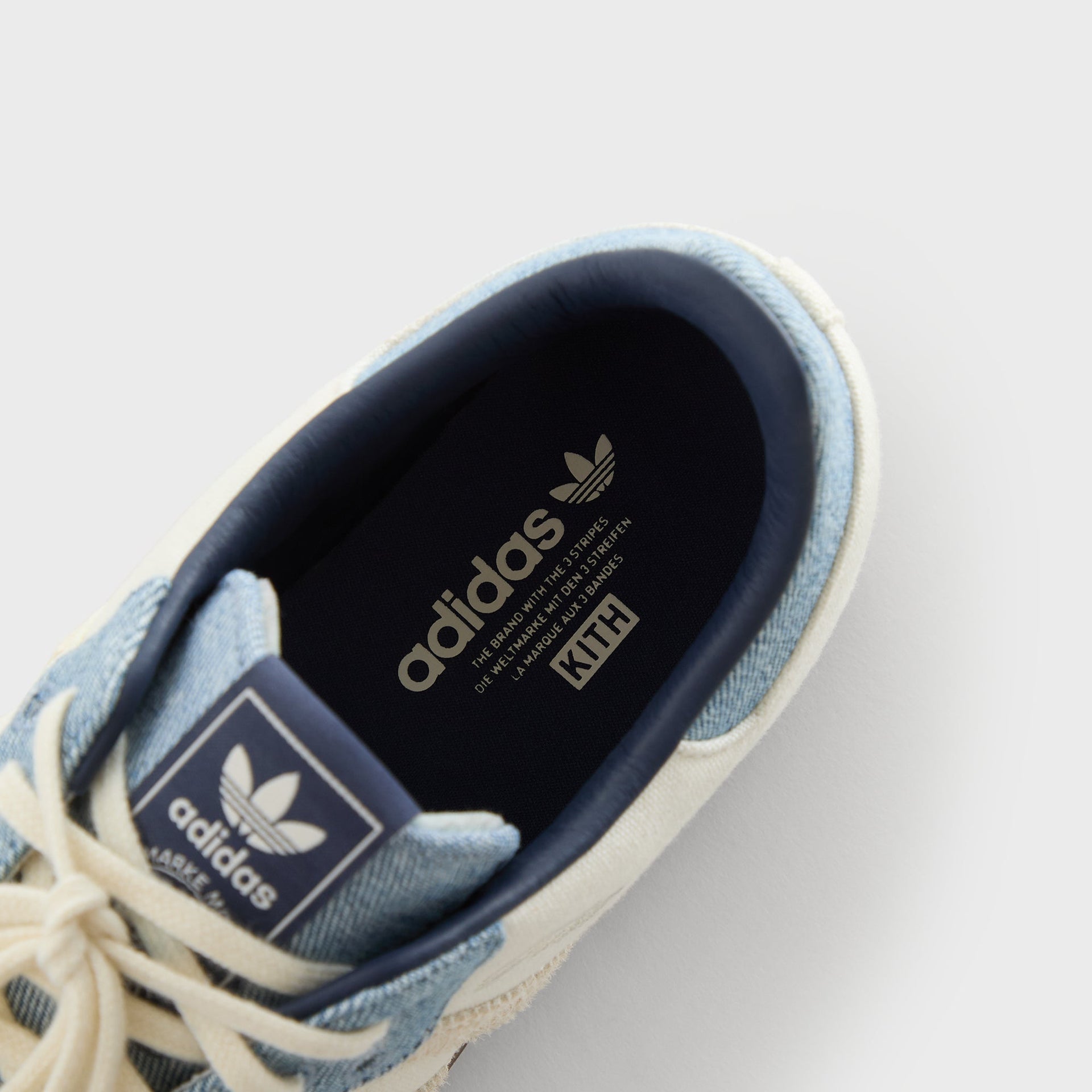 Close-up inside the Kith for adidas Originals Samba Denim/White, showing the navy adidas-branded sockliner with a Kith tag