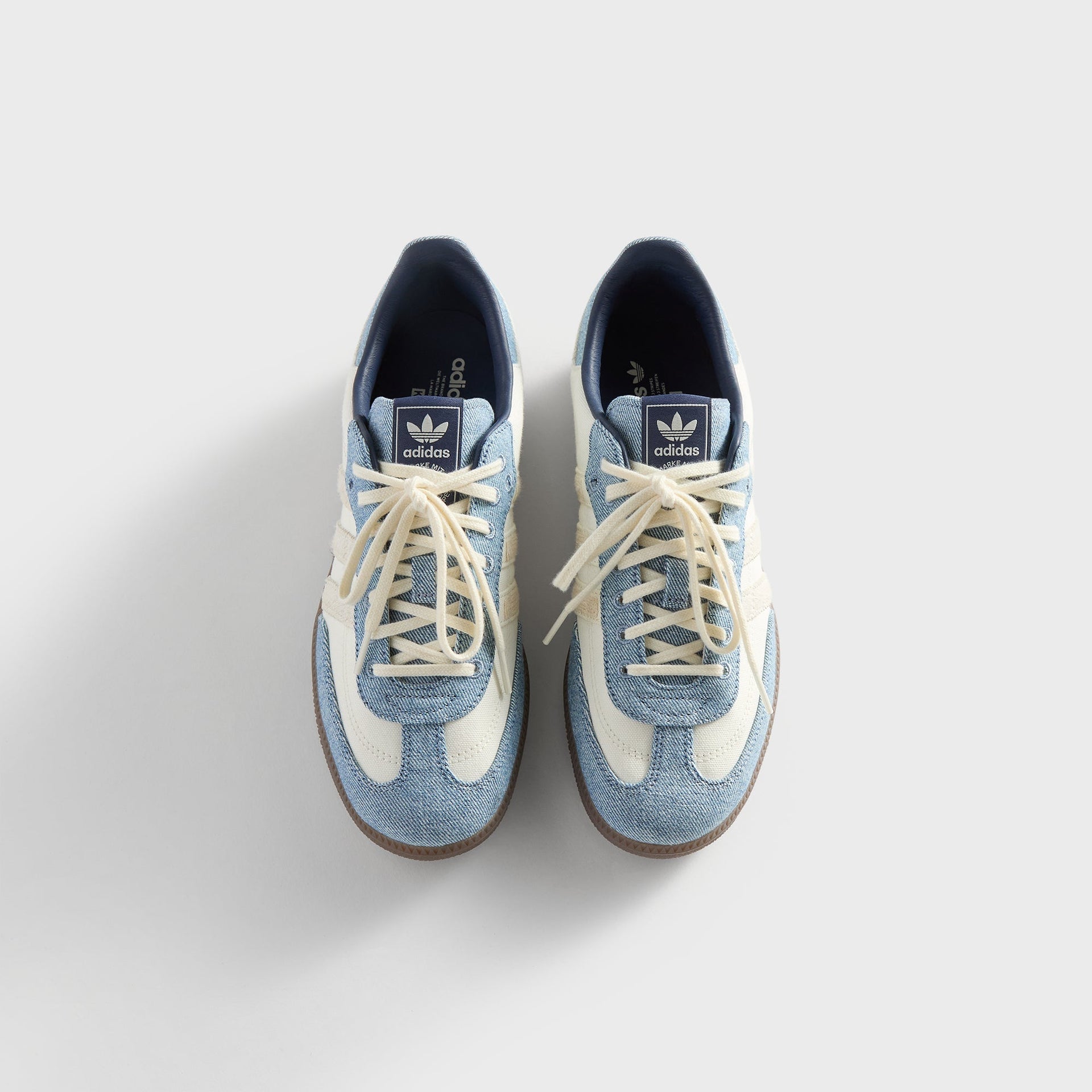 Kith for adidas Originals Samba sneakers in Denim/White, top-down view of the laced pair showing the denim tongue and cream stripes