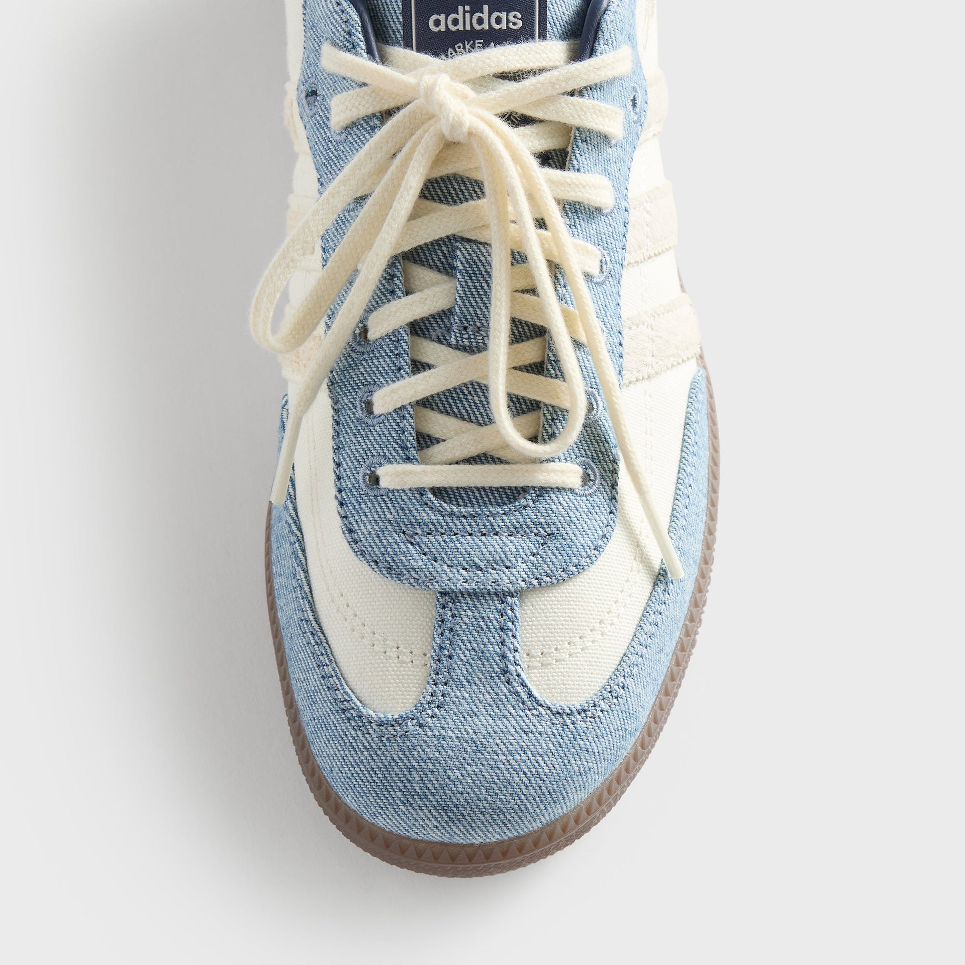 Close-up of the Kith for adidas Originals Samba Denim/White toe box, showing the denim overlay, cream laces, and stitched detailing