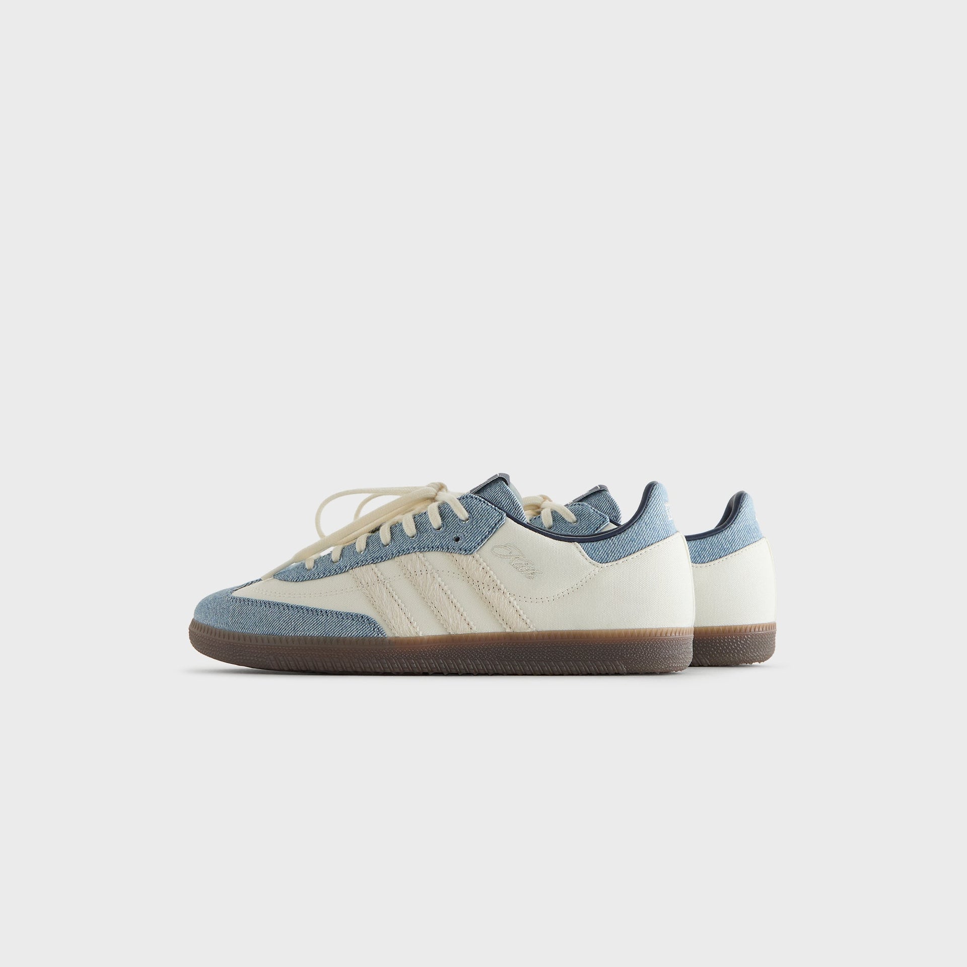 Kith for adidas Originals Samba "Denim" sneaker pair in white canvas and denim, angled side view with gum soles