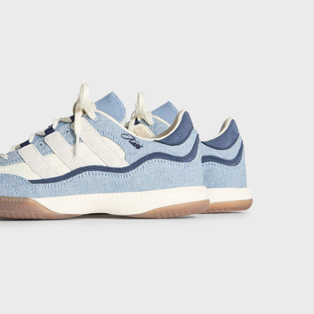 Kith for adidas Football Supernova Indoor in Denim/Gum, rear three-quarter view showing navy heels, Kith script and gum soles