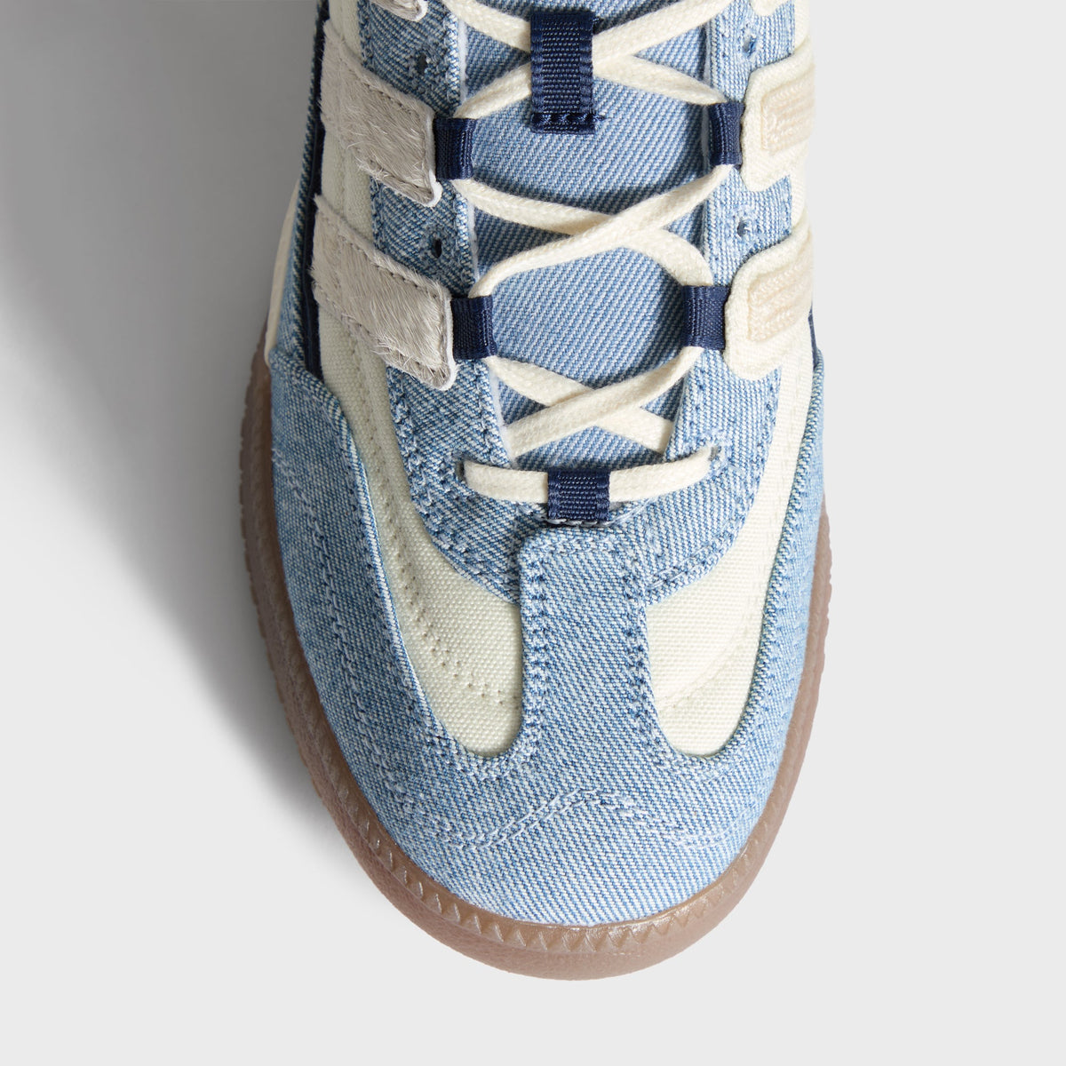 Kith for adidas Football Supernova Indoor in Denim/Gum, overhead close-up of the laced denim toe box and gum midsole