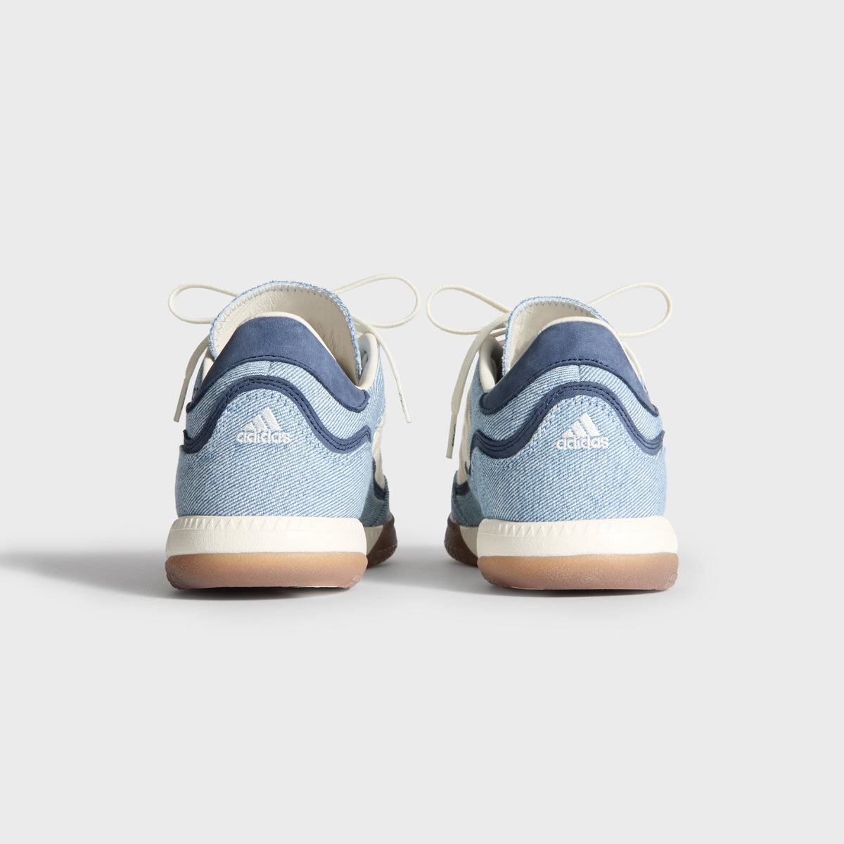 Kith for adidas Football Supernova Indoor in Denim/Gum, rear view of the pair showing adidas Badge of Sport on denim heels