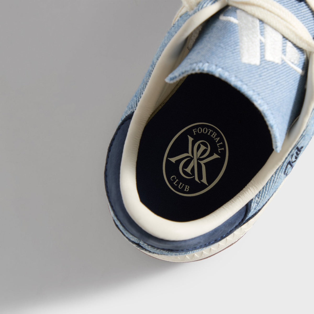 Kith for adidas Football Supernova Indoor in Denim/Gum, close-up of the navy insole with Kith Football Club roundel logo