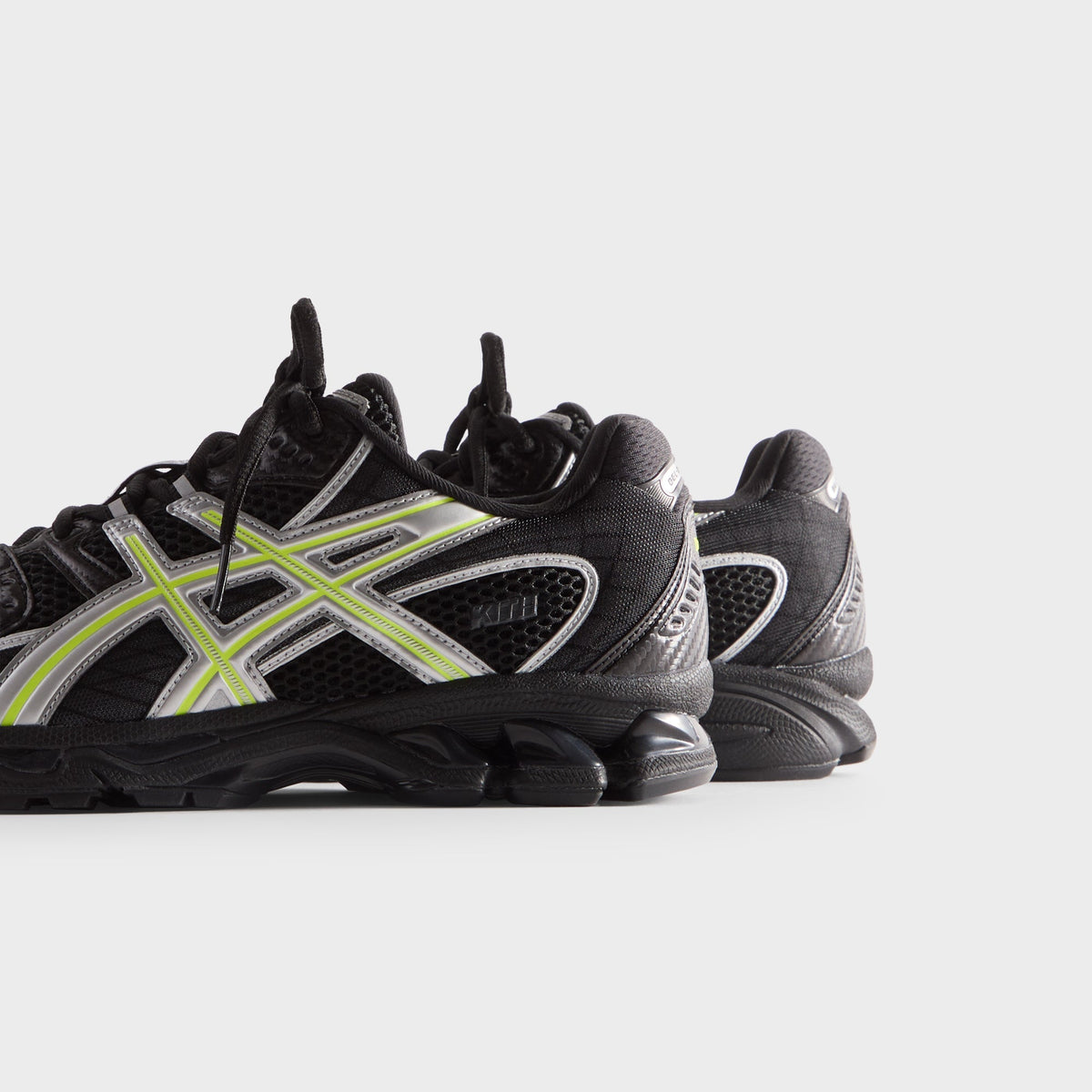 Kith for ASICS GEL-NIMBUS 10.1 black and silver, rear side close view of heel gel unit and neon yellow stripe overlays