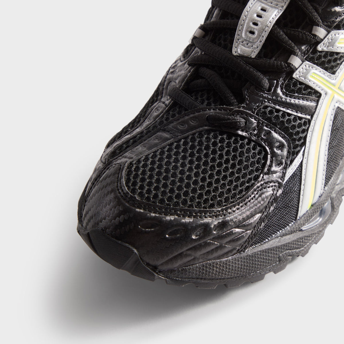 Kith for ASICS GEL-NIMBUS 10.1 black and silver, toe box close-up of perforated mesh and textured carbon-look overlays