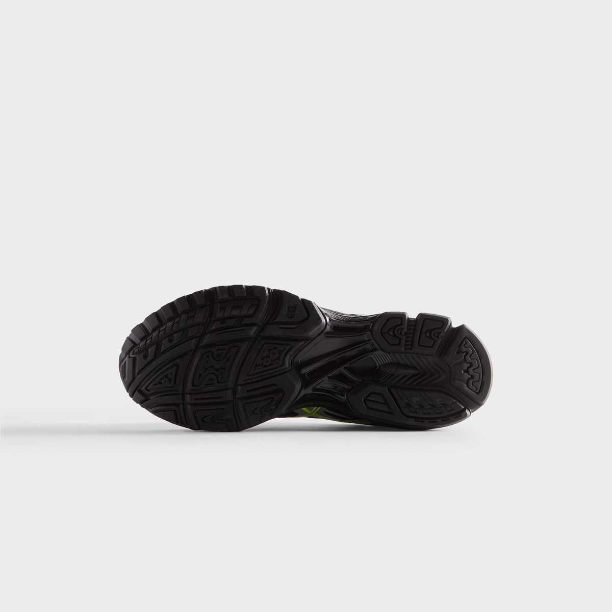 Kith for ASICS GEL-NIMBUS 10.1 black and silver, outsole view showing black tread pattern with lime accent at the edge