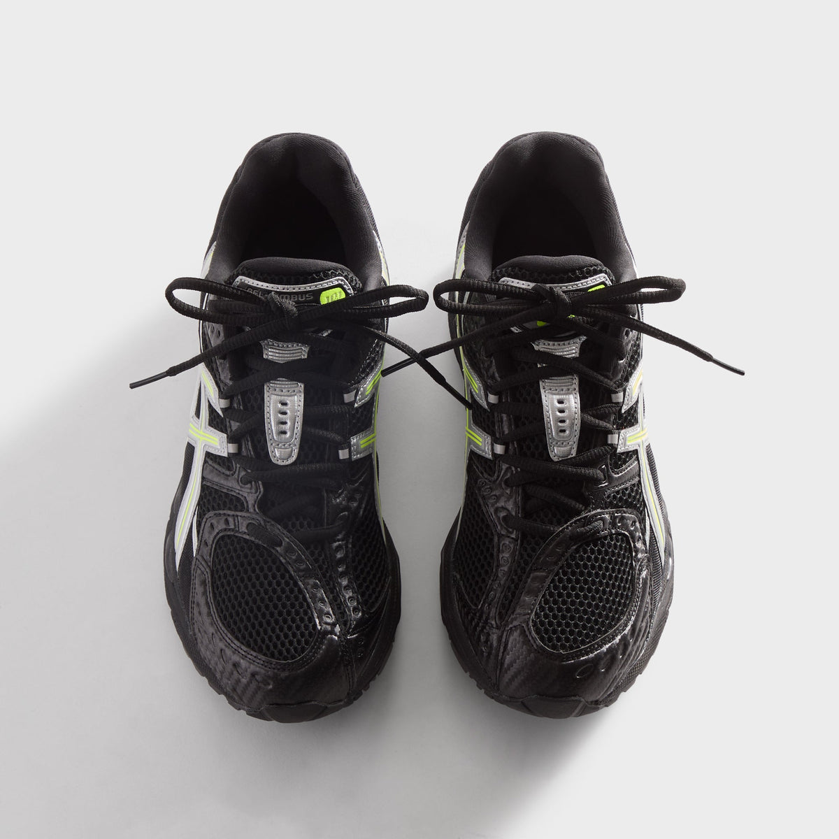 Kith for ASICS GEL-NIMBUS 10.1 black and silver, top-down view of pair with crossed black laces and silver lace loops