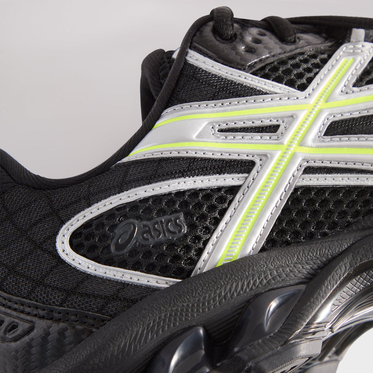 Kith for ASICS GEL-NIMBUS 10.1 black and silver, side detail of silver and neon stripes over mesh above midsole gel pod