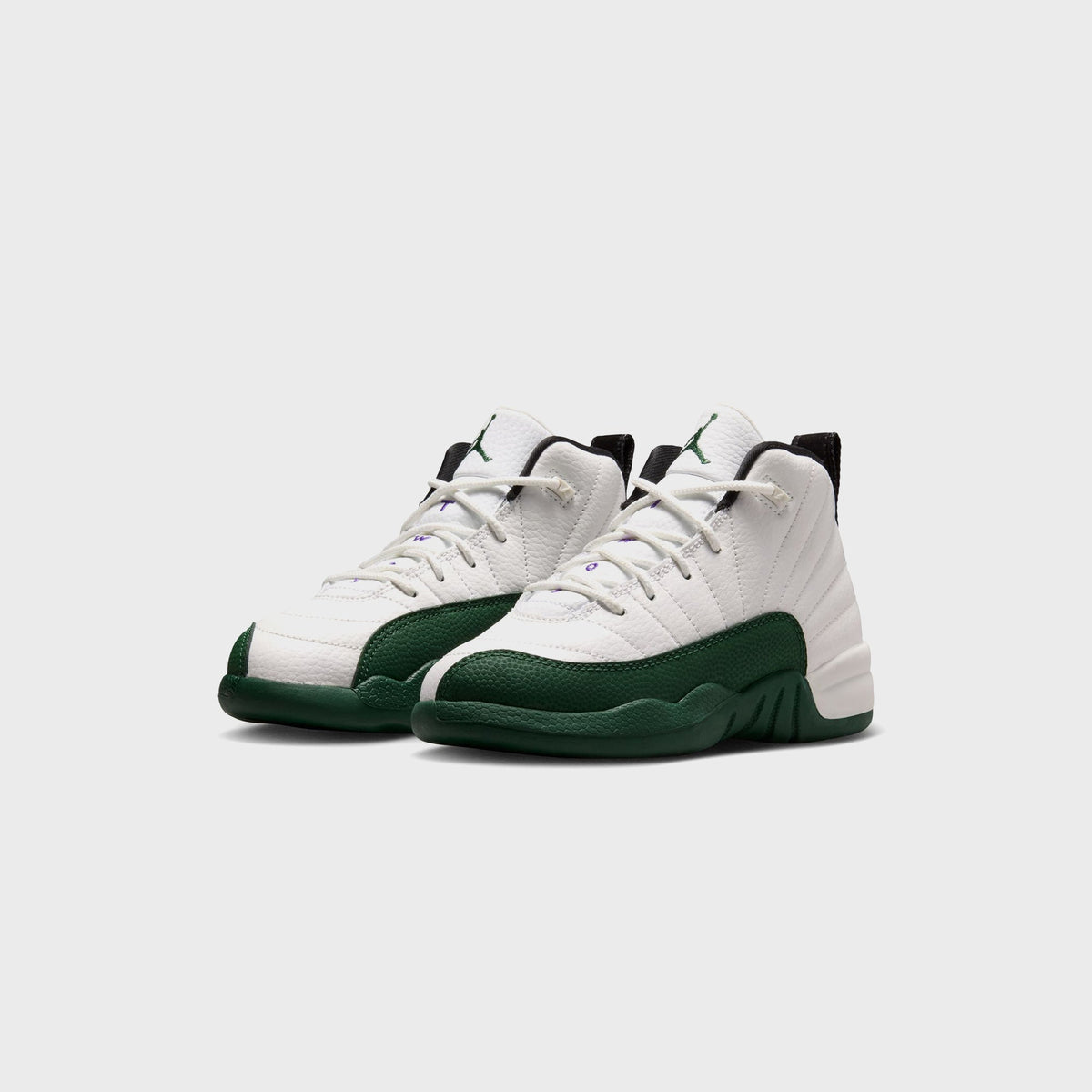 Pair of Jordan PS Air Jordan 12 Retro preschool sneakers in white and green, angled front view
