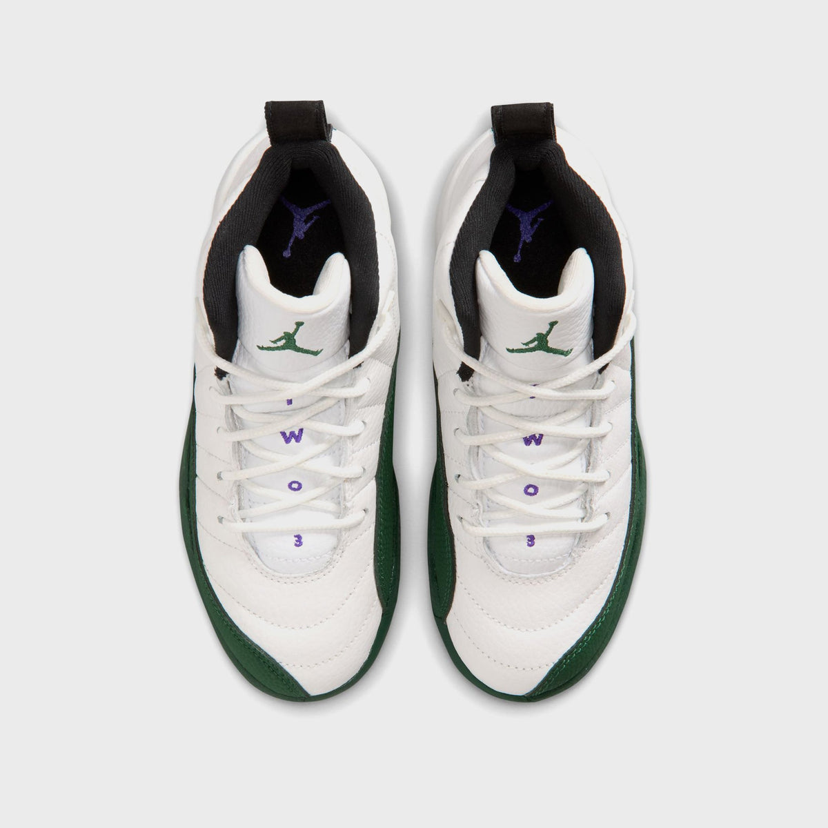 Top-down view of Jordan PS Air Jordan 12 Retro preschool pair showing green Jordan Wings embroidery on the tongue