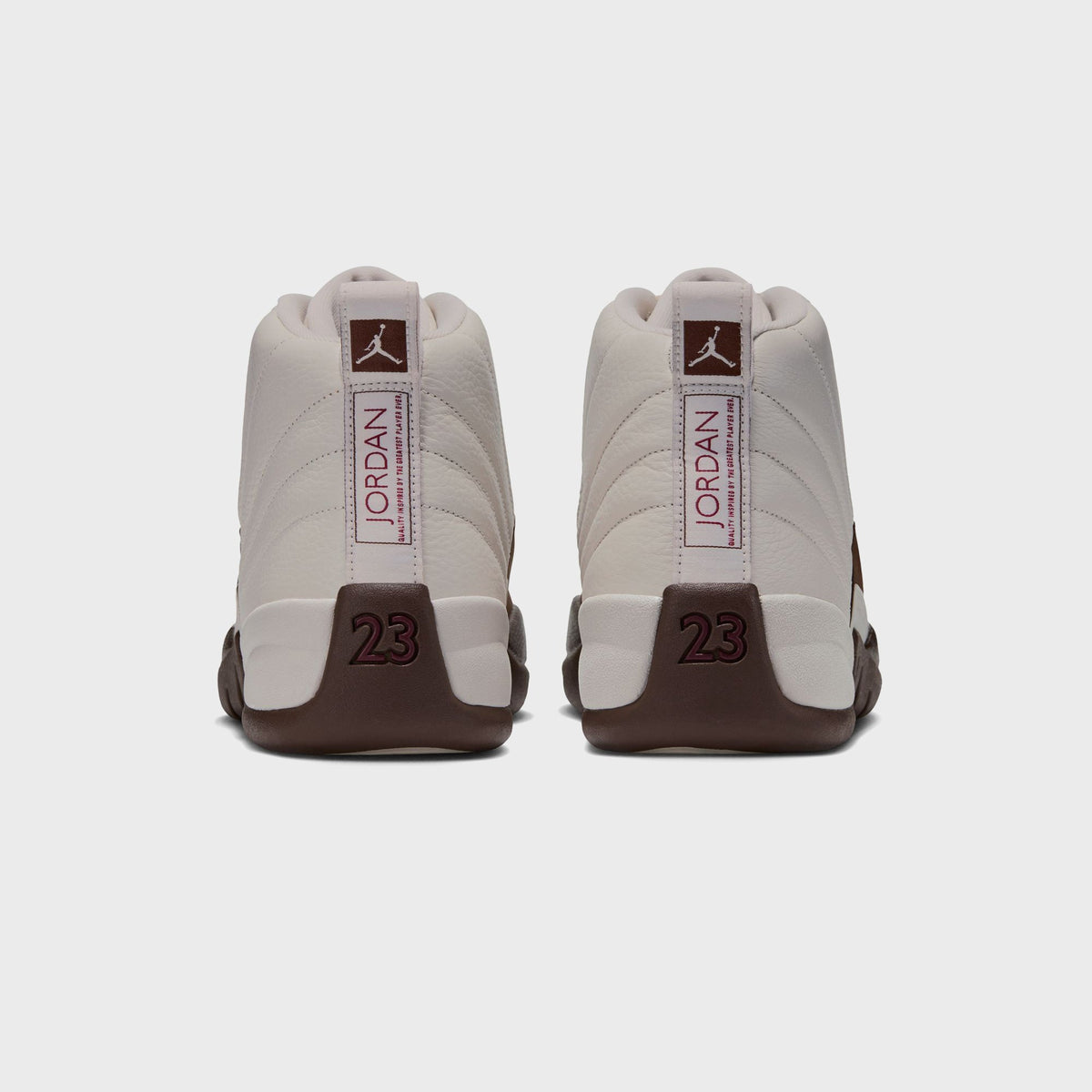 Rear view of a pair of Air Jordan 12 Retro in Light Orewood Brown showing Jordan heel tab, Jumpman logo and number 23 on brown heel