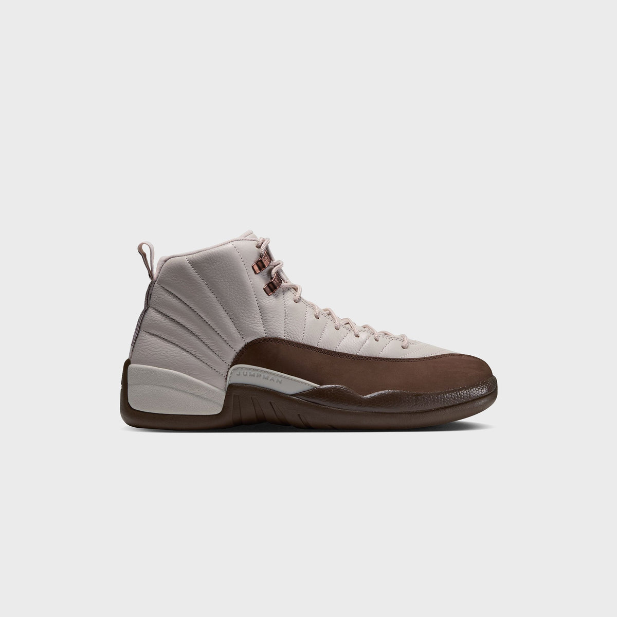 Air Jordan 12 Retro in Light Orewood Brown, cream leather upper with brown suede mudguard and rose-gold eyelets, side view