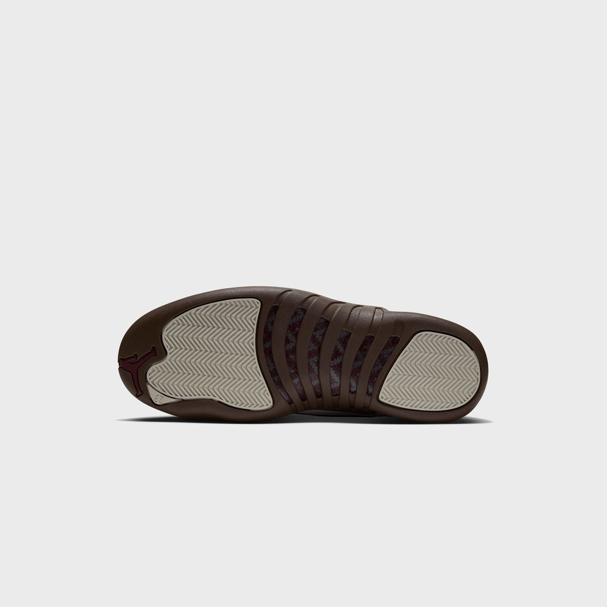 Outsole of Air Jordan 12 Retro Light Orewood Brown with Cacao Wow brown rubber and cream herringbone traction pattern