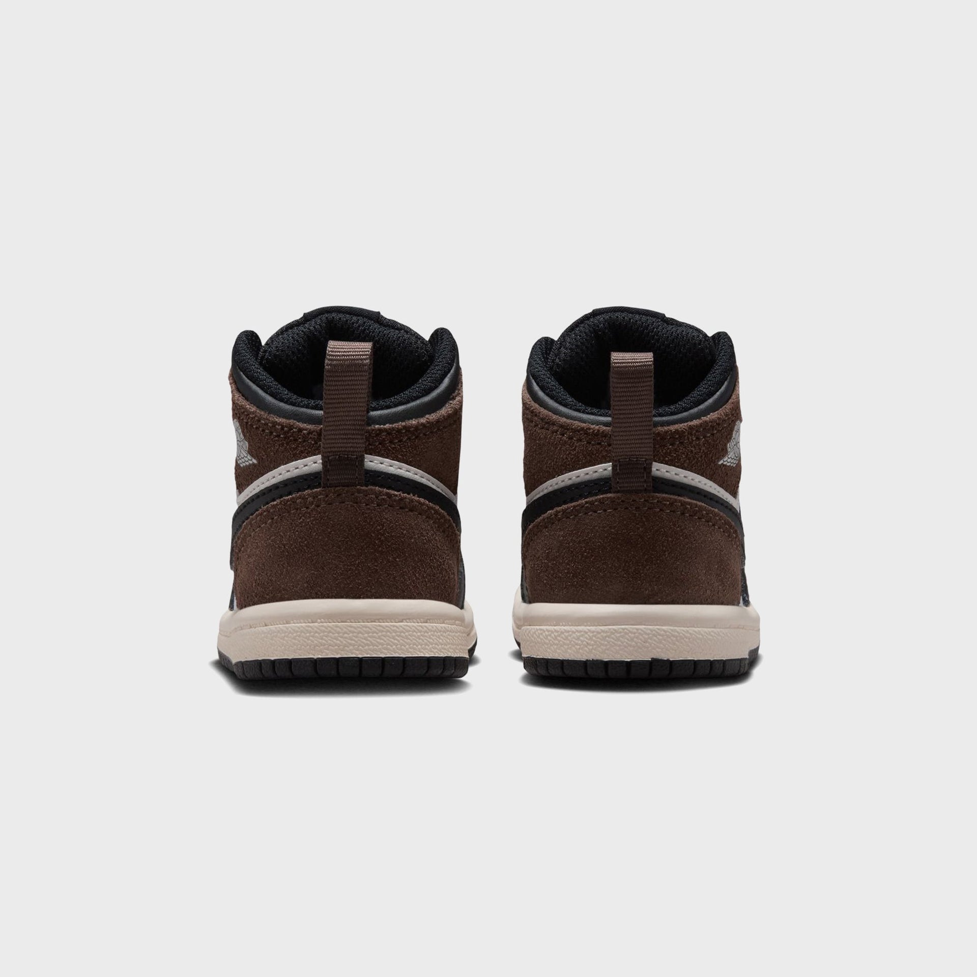 Jordan 1 Mid toddler pair, rear view of palomino brown suede heels with silver Wings logos and sail midsoles