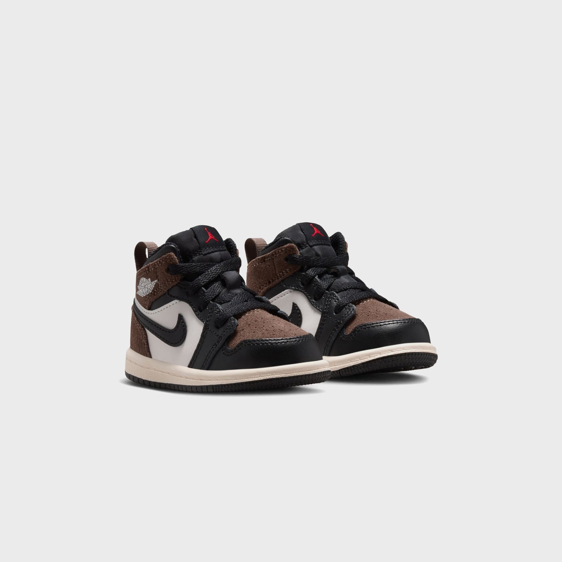 Jordan 1 Mid toddler pair, front three-quarter view with brown suede toes, phantom panels and red Jumpman tongues