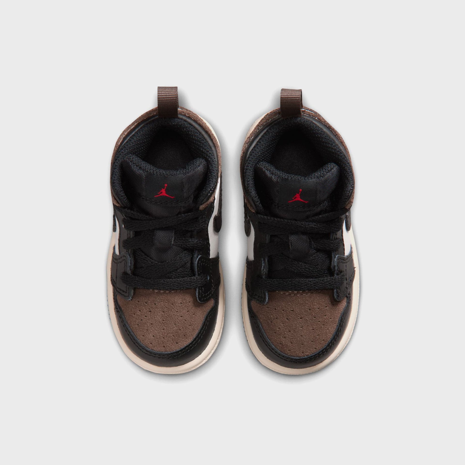 Jordan 1 Mid toddler pair from above, brown suede perforated toes, black laces and red Jumpman tongue logos
