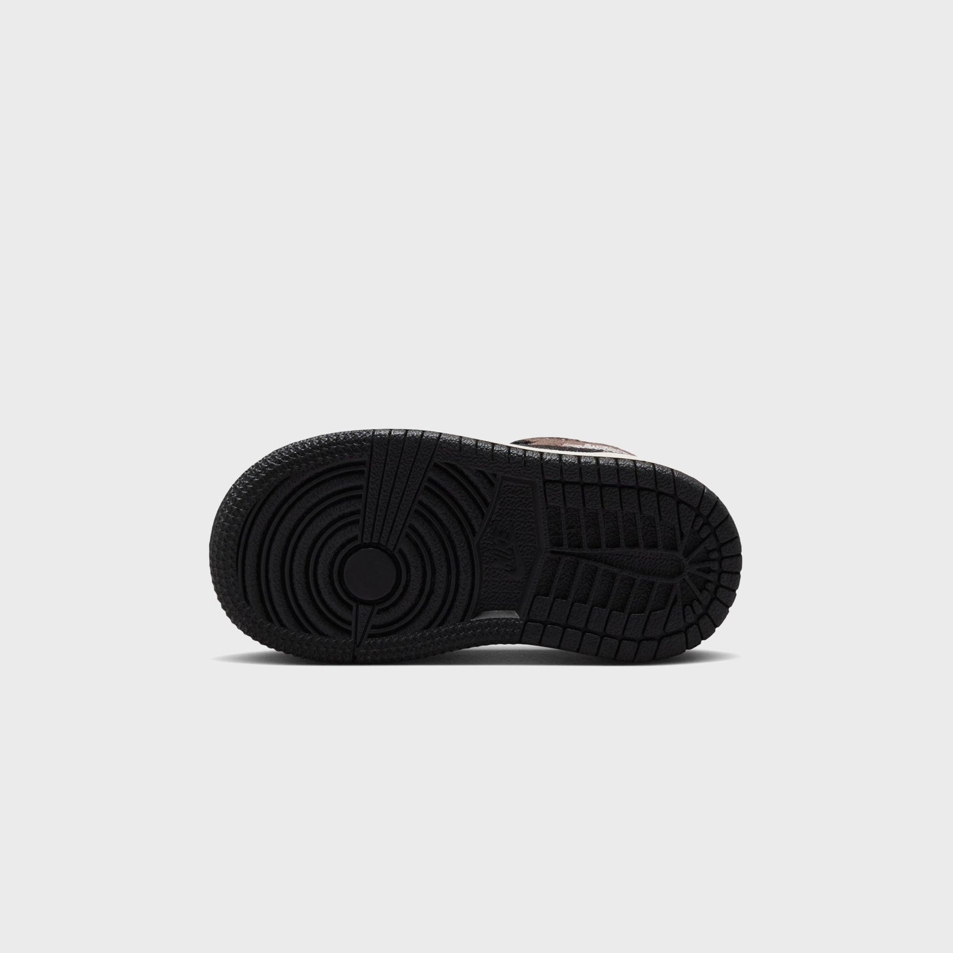 Jordan 1 Mid toddler black rubber outsole with circular pivot tread pattern and Nike branding