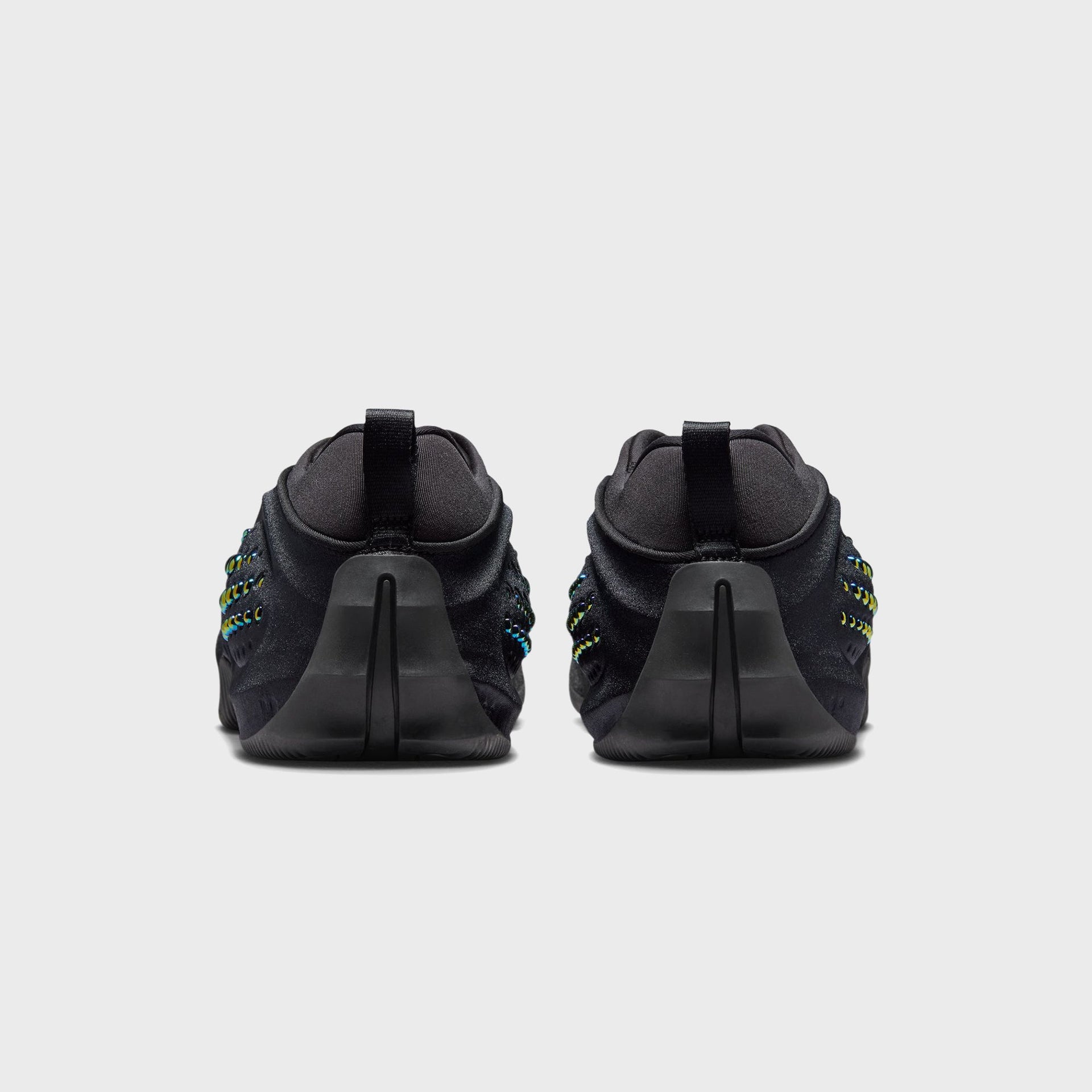Nike WMNS First Sight Shadow Triple Black, rear view of the pair showing black heel pull tabs and sculpted molded heel counters