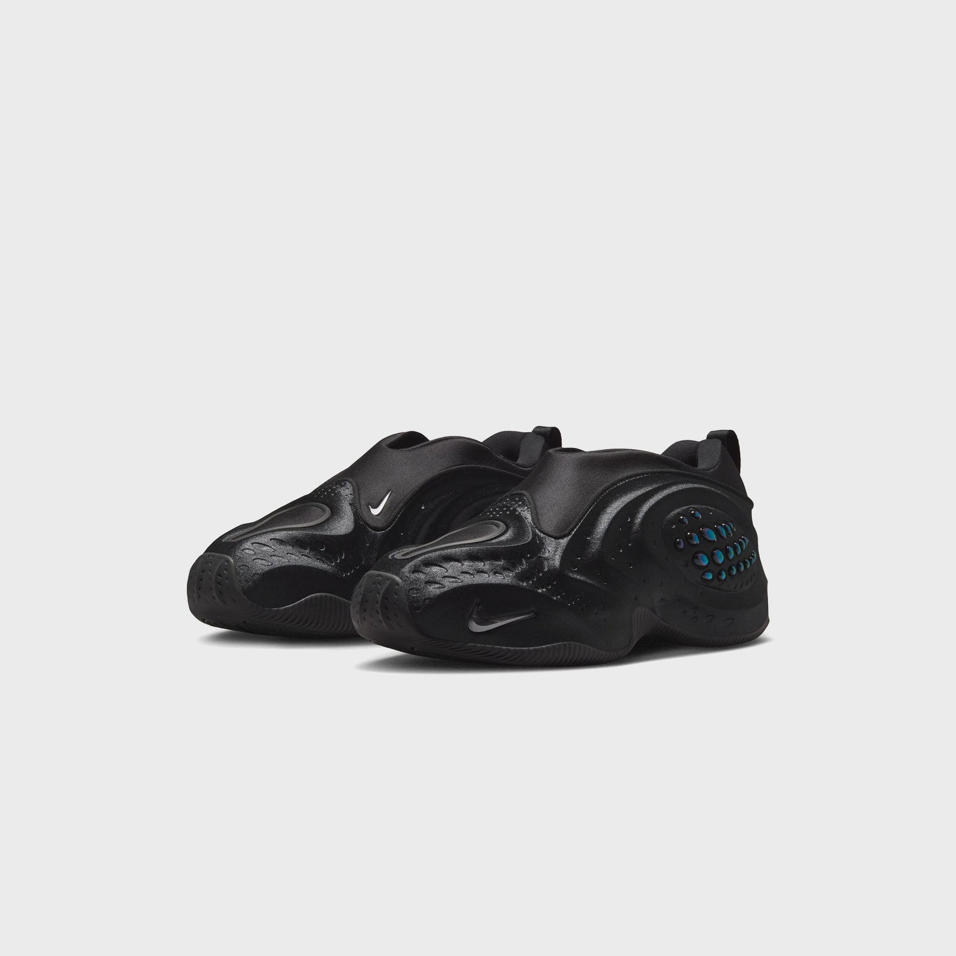 Nike WMNS First Sight Shadow Triple Black, front three-quarter view of the pair with sculpted black shells and dark Nike swooshes