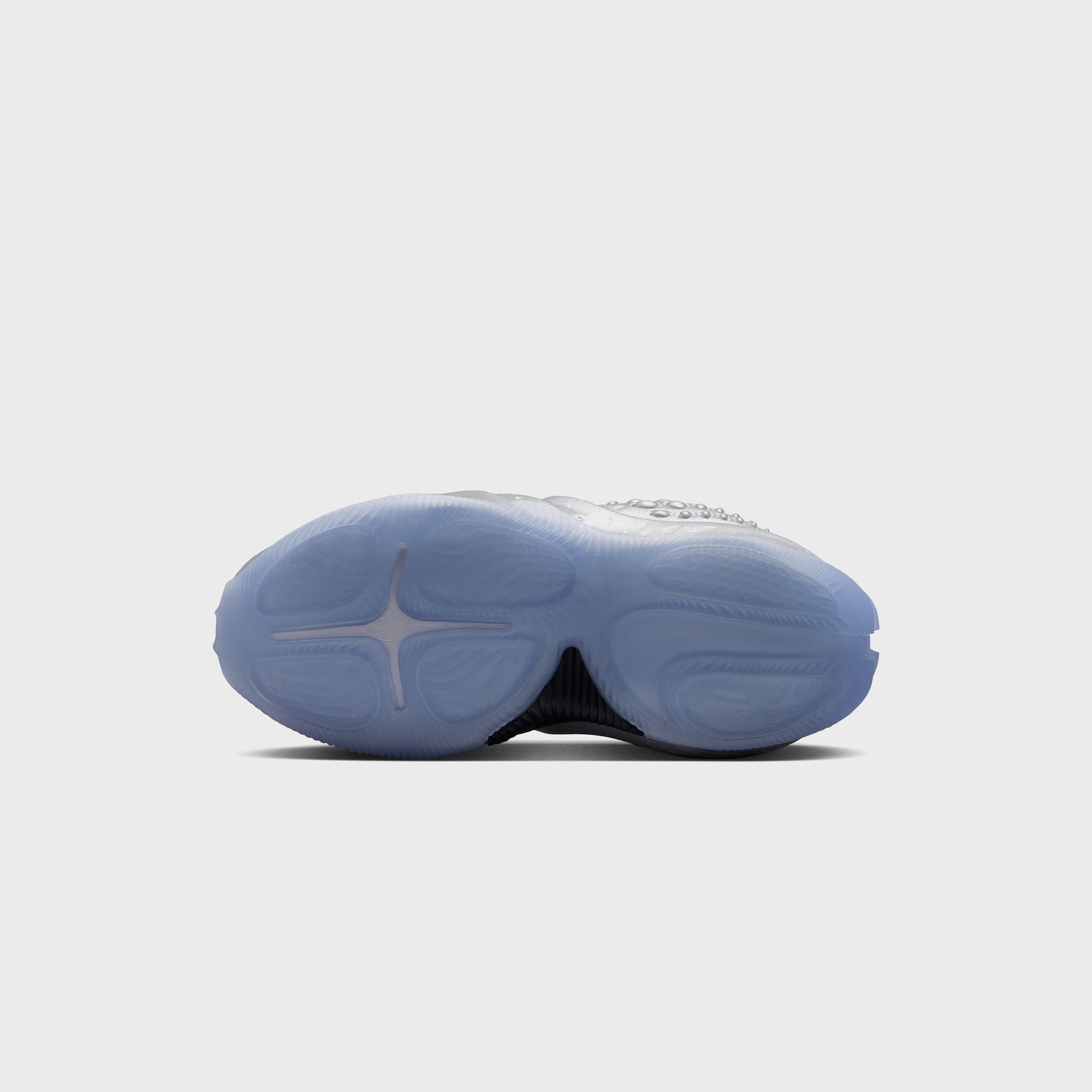 Nike WMNS First Sight Shadow Metallic Silver, bottom outsole view with translucent icy-blue sole and cross-shaped flex grooves