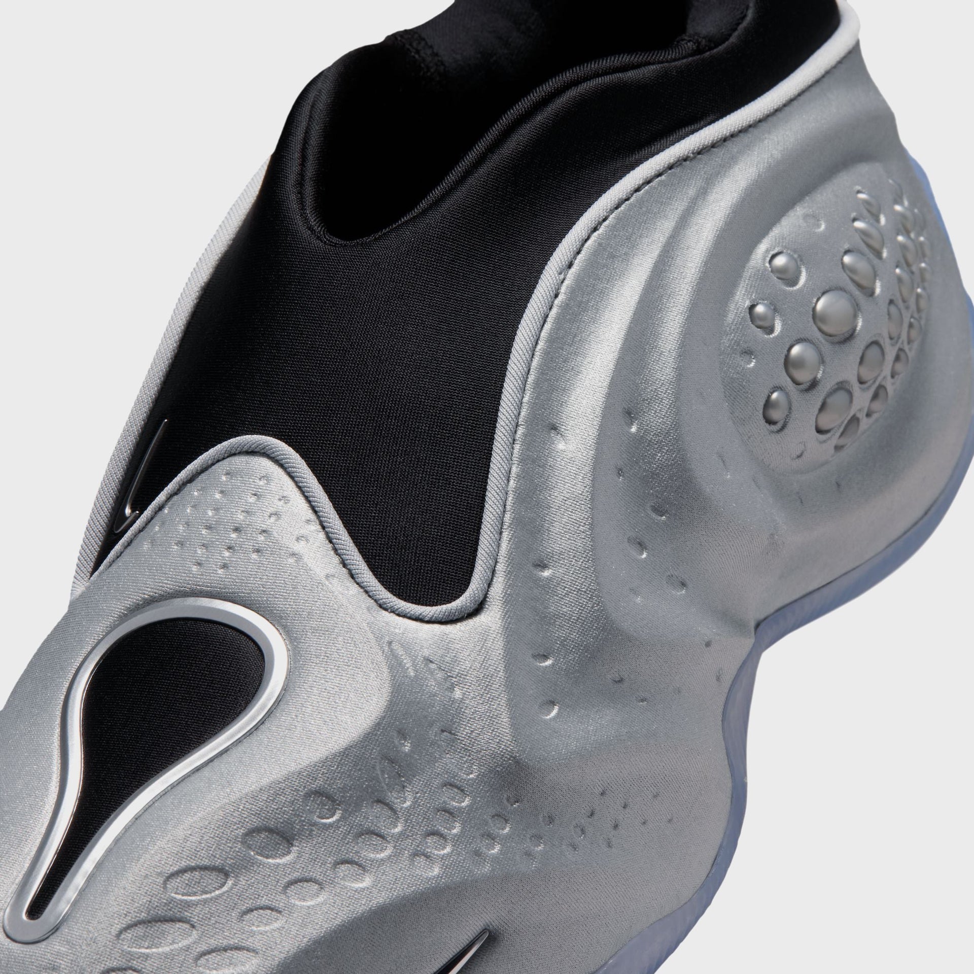 Nike WMNS First Sight Shadow Metallic Silver, close-up of the satiny silver upper, teardrop swoosh window and domed bubble pod
