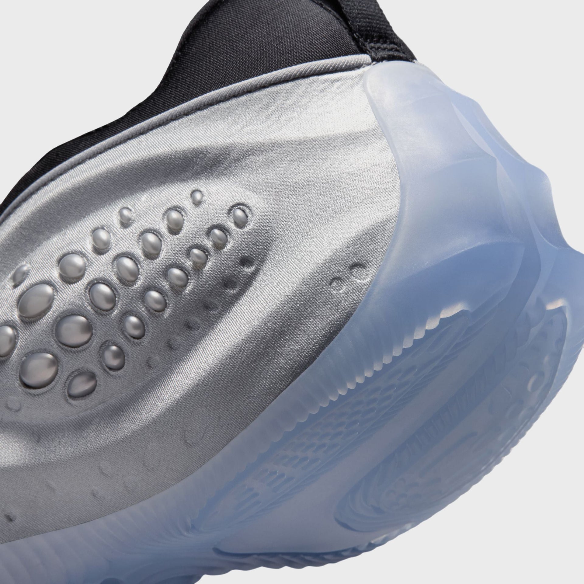 Nike WMNS First Sight Shadow Metallic Silver, macro of the domed silver bubble pod beside the translucent icy midsole
