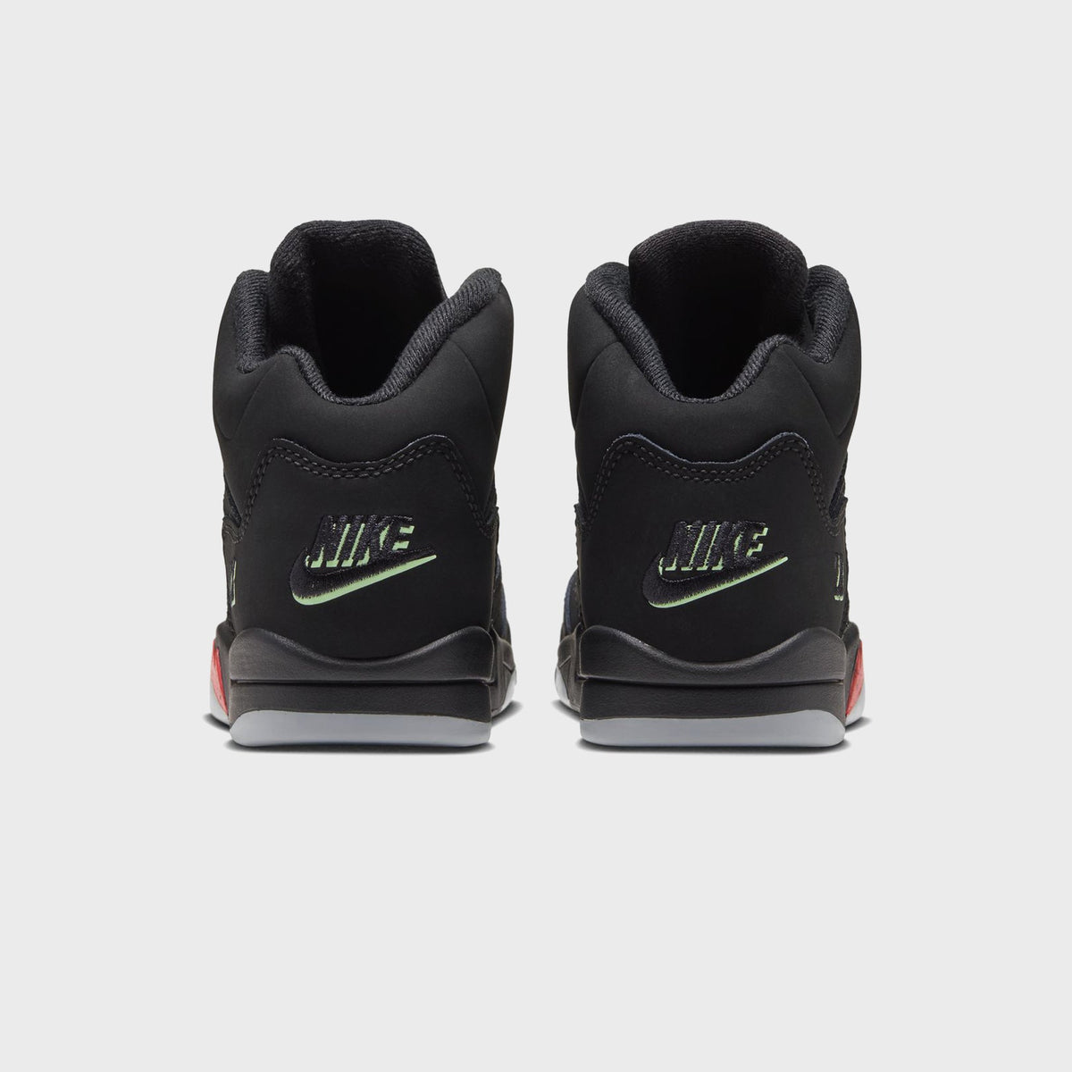Rear view of Jordan PS Jordan 5 Retro black with green Nike heel branding and grey sole
