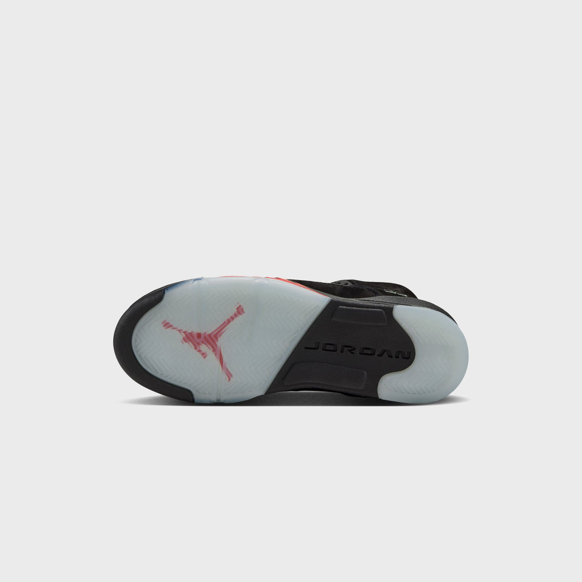 Outsole of Jordan GS Air Jordan 5 Retro with red Jumpman logo on translucent icy tread