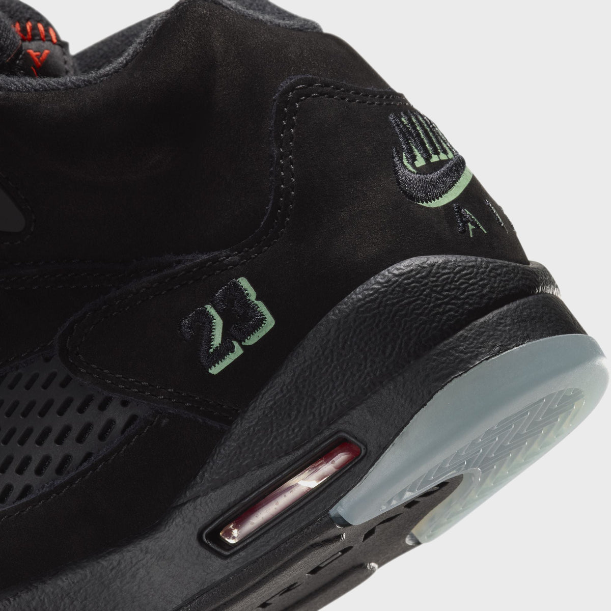 Close-up of Jordan GS Air Jordan 5 Retro heel with green Nike Air and 23 detail, visible Air unit and icy sole