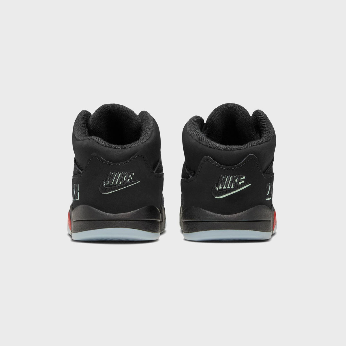 Rear view of Jordan TD Jordan 5 Retro black toddler sneakers with Nike heel branding and icy blue sole
