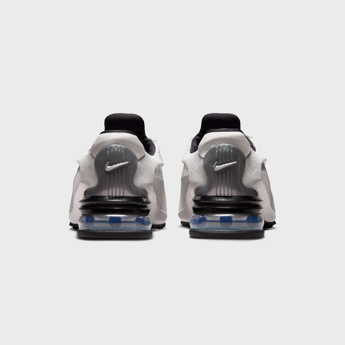 Nike Air Max Dolce sneakers in Metallic Silver and Black, rear view highlighting the ridged heel counter and visible Air cushioning