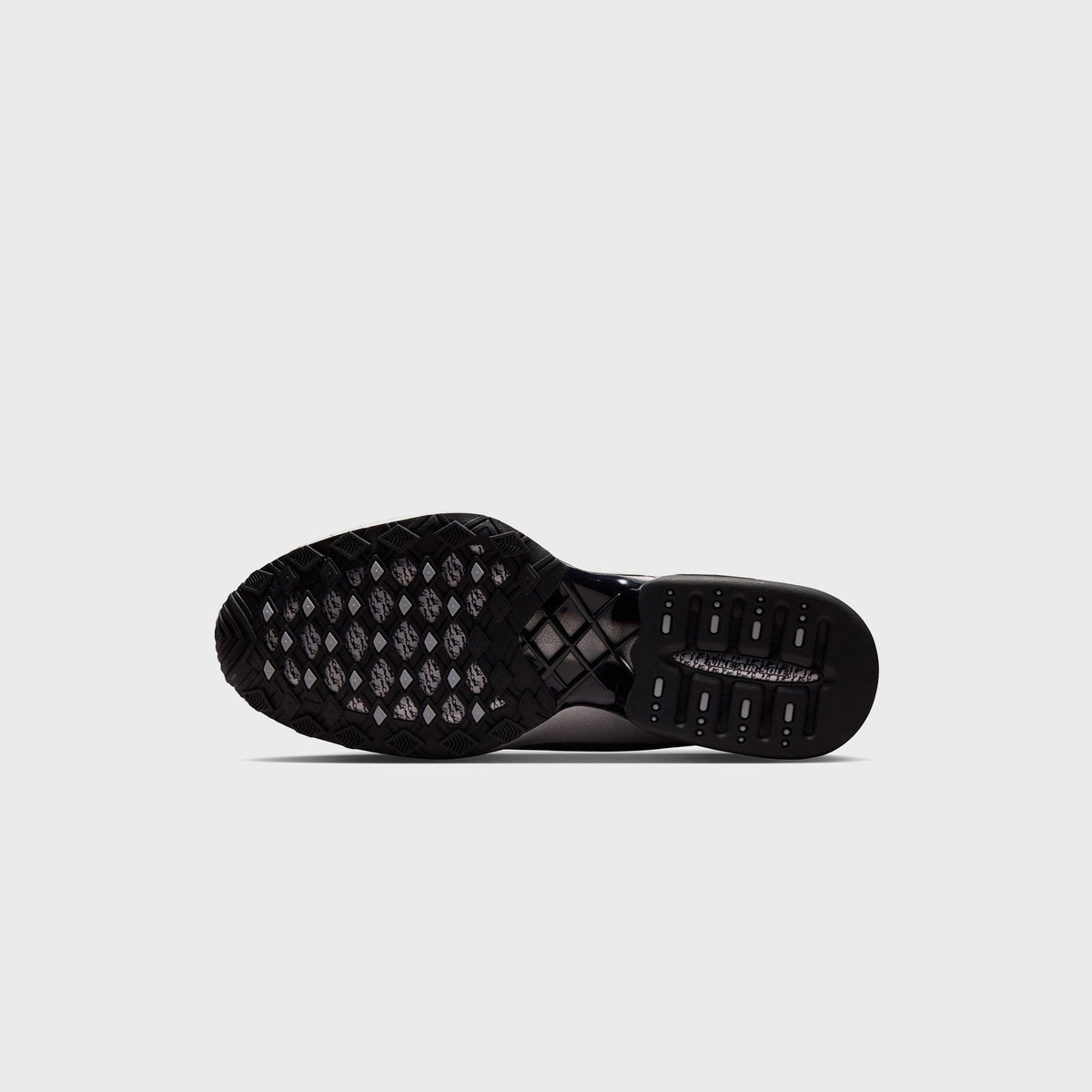Nike Air Max Dolce sneaker outsole in Black, close-up of the diamond-lugged tread pattern