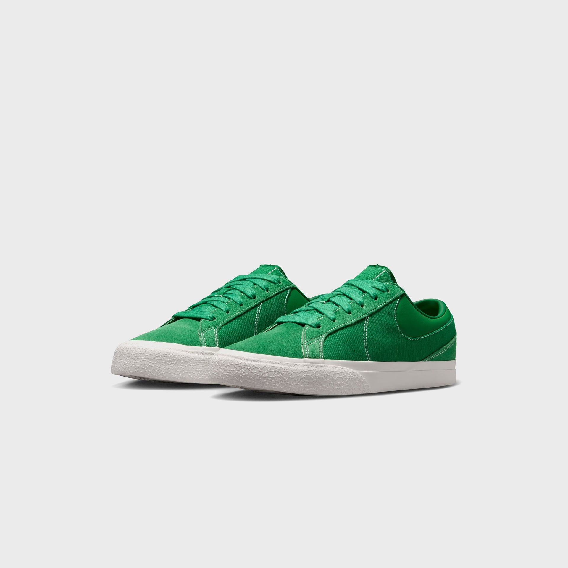 Nike Blazy Pine Green pair angled from the front, showing green suede toes, tonal green Swoosh and white sail cupsoles