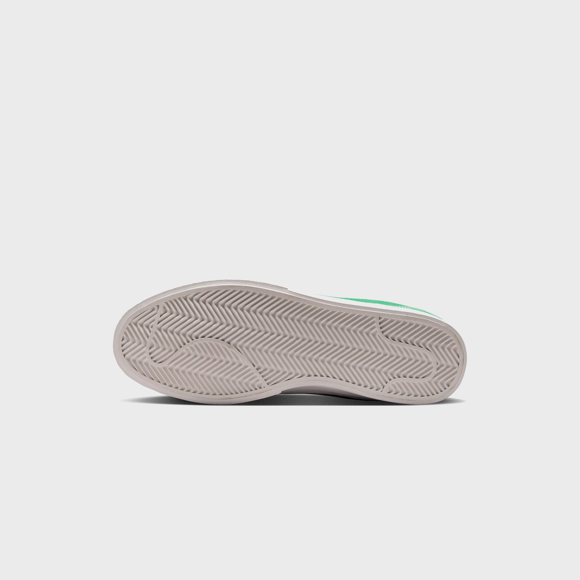 Bottom outsole of the Nike Blazy in cream herringbone tread with a glimpse of the Pine Green suede upper