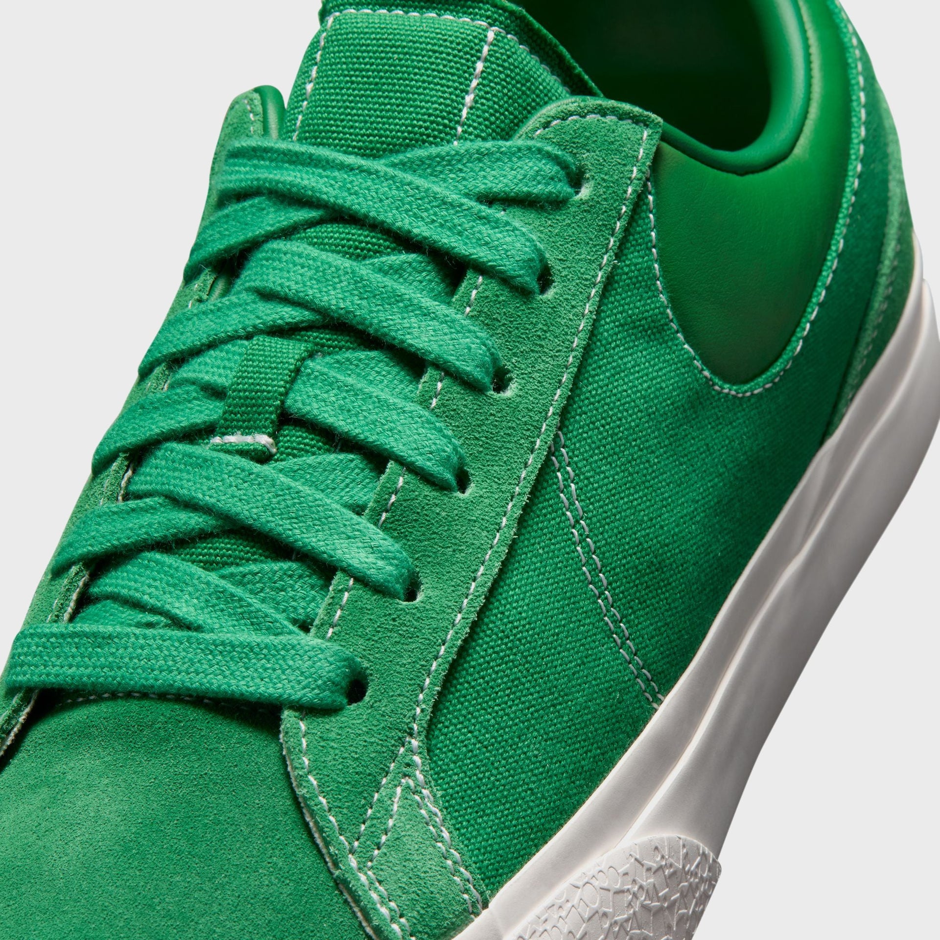 Detail of the Nike Blazy Pine Green toe box, green flat laces, tonal green suede Swoosh and white contrast stitching