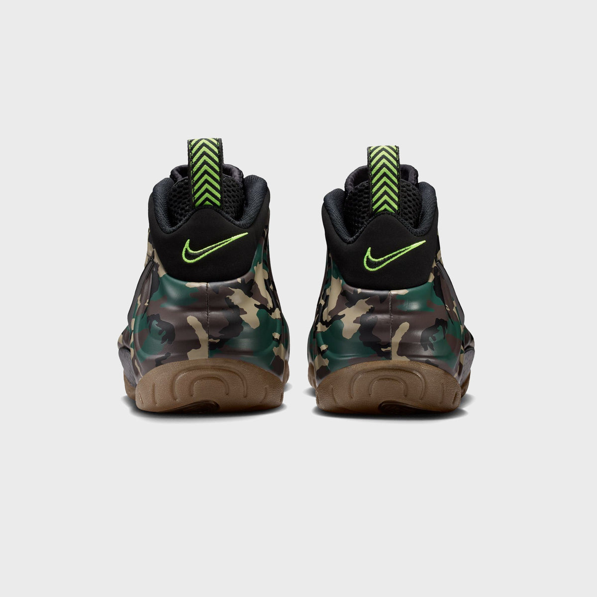Heel view of Nike Air Foamposite Pro camo sneakers with black volt-embroidered Swoosh on each heel